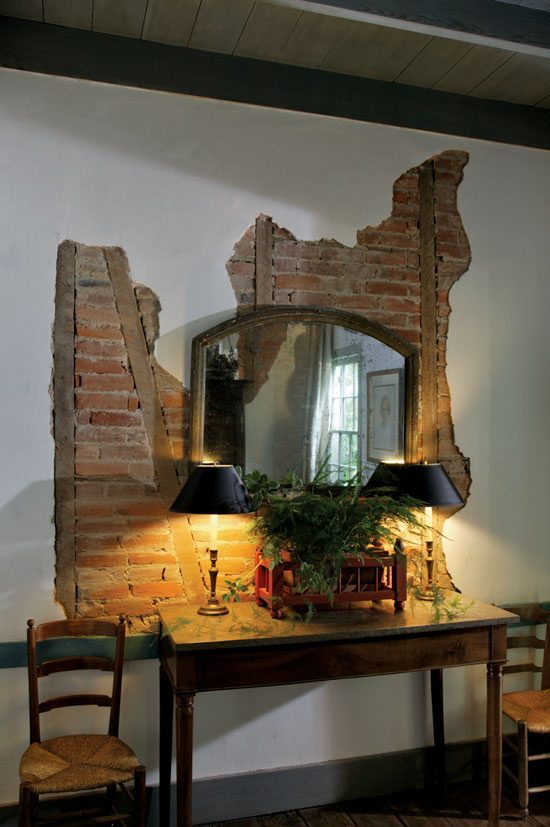 The interior brick walls were disassembled for moving, reassembled on site, and plastered for an authentic look and feel.